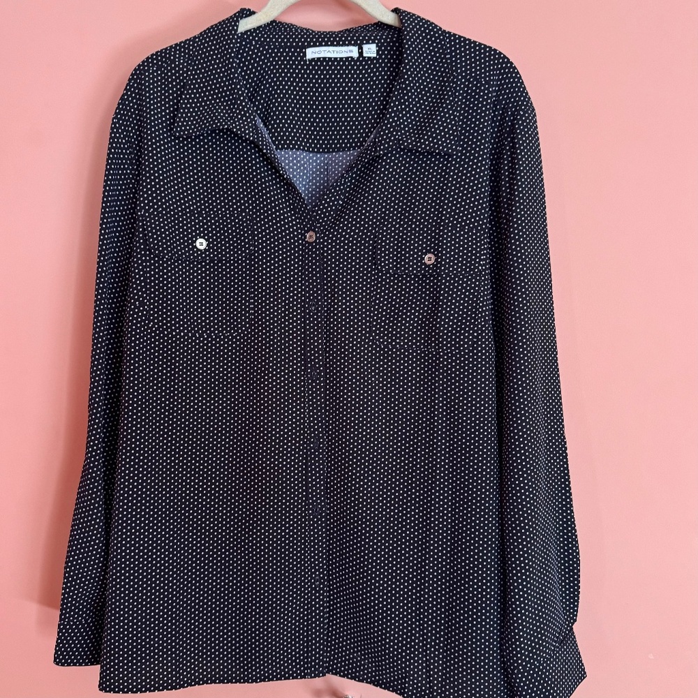 Black & white polkbutton down shirt with collar, pockets and adjustable sleeves.